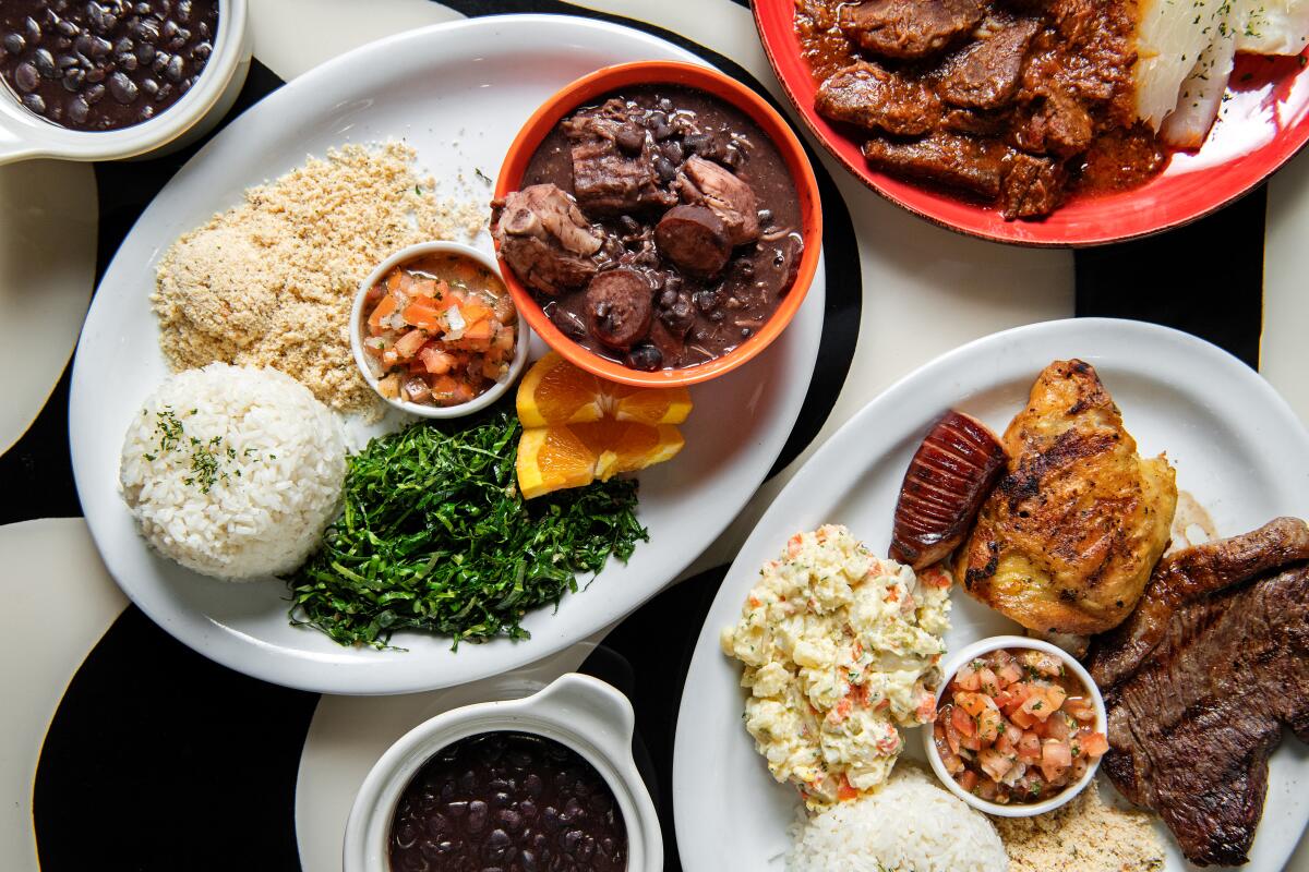 REDONDO BEACH, CA - NOVEMBER 07: from left: Feijoada, Carne de Panela (pot roast), and the BBQ plate from Panelas Brazillian Cuisine on Tuesday, Nov. 7, 2023 in Redondo Beach, CA. (Mariah Tauger / Los Angeles Times)