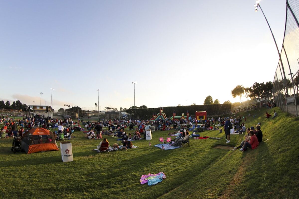 Visitors get ready for the fireworks show at Recreation park in El Segundo.