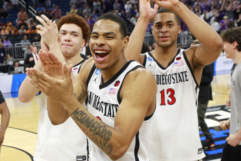 San Diego State's Elijah Saunders, left, Keshad Johnson and Jaedon LeDee celebrate after being Furman during the second round of the NCAA Tournament in Orlando on Saturday. They now play No. 1 seed Alabama as they attempt to advance to the Elite Eight.