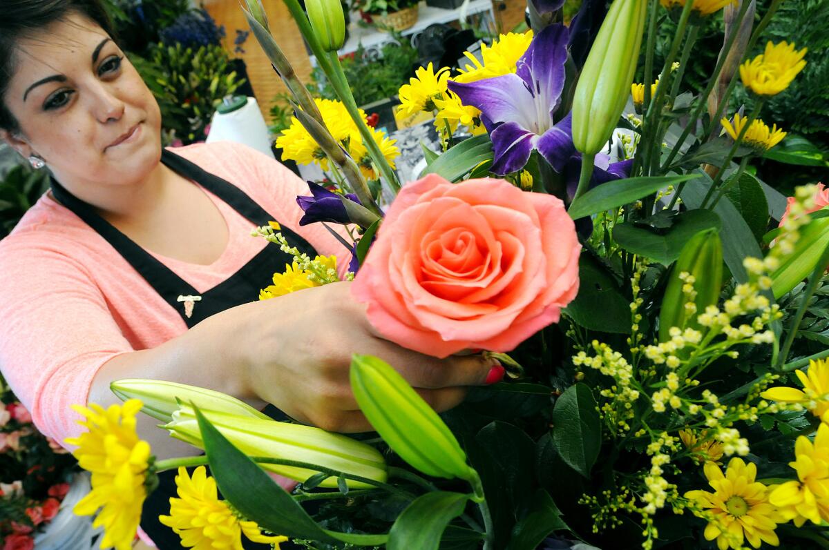 A floral designer places a rose into a Mother’s Day arrangement. About 43.5 million women between the ages of 15 and 50 have children, according to the U.S. Census Bureau.