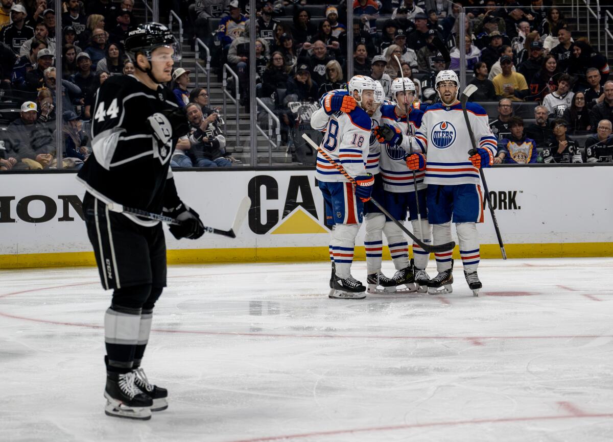 Kings defenseman Mikey Anderson skates in front of Oilers players after a goal by Edmonton's Klim Kostin.