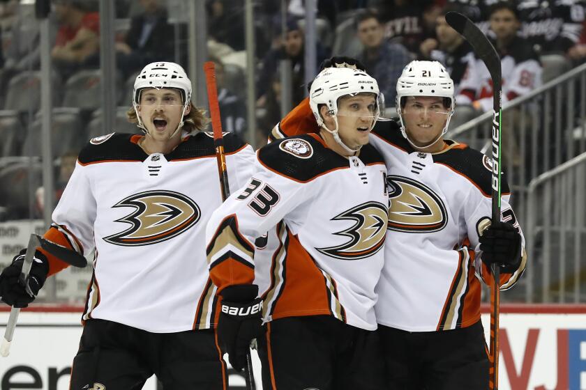 Anaheim Ducks right wing Jakob Silfverberg (33) celebrates with Simon Benoit (13) and Isac Lundestrom (21) after scoring a goal against the New Jersey Devils during the first period of an NHL hockey game Tuesday, Oct. 18, 2022, in Newark, N.J. (AP Photo/Noah K. Murray)