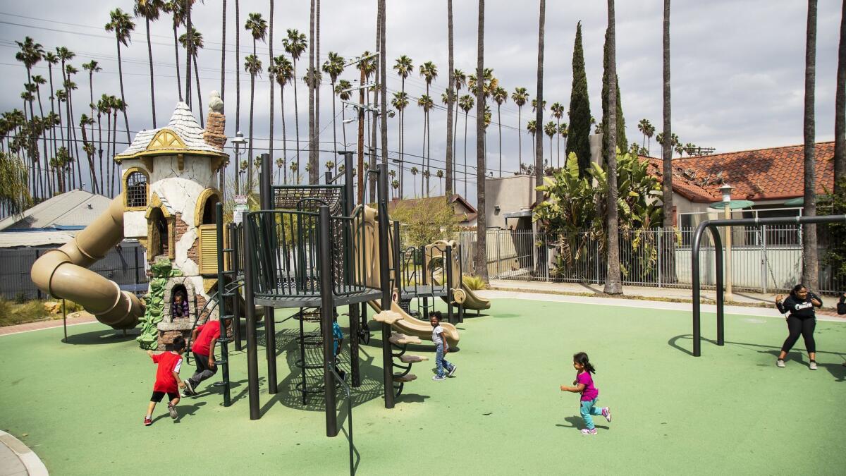 Children play at the renovated Leslie Shaw Park in Jefferson Park in Los Angeles.