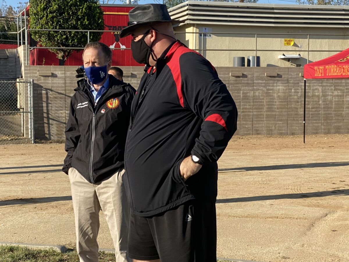 LAUSD Supt. Austin Beutner (left) talks with Taft football coach Aron Gideon after students were allowed to return to campus.
