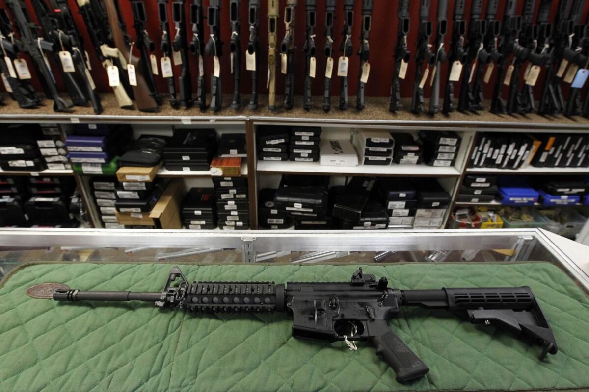 An AR-15 style rifle is displayed at the Firing-Line indoor range and gun shop in Aurora, Colo., in 2012.