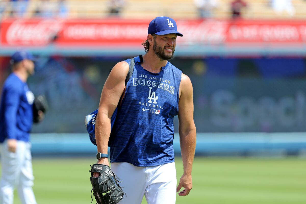 Dodgers starting pitcher Clayton Kershaw walks on the field at Dodger Stadium before Sunday's game against the Reds.