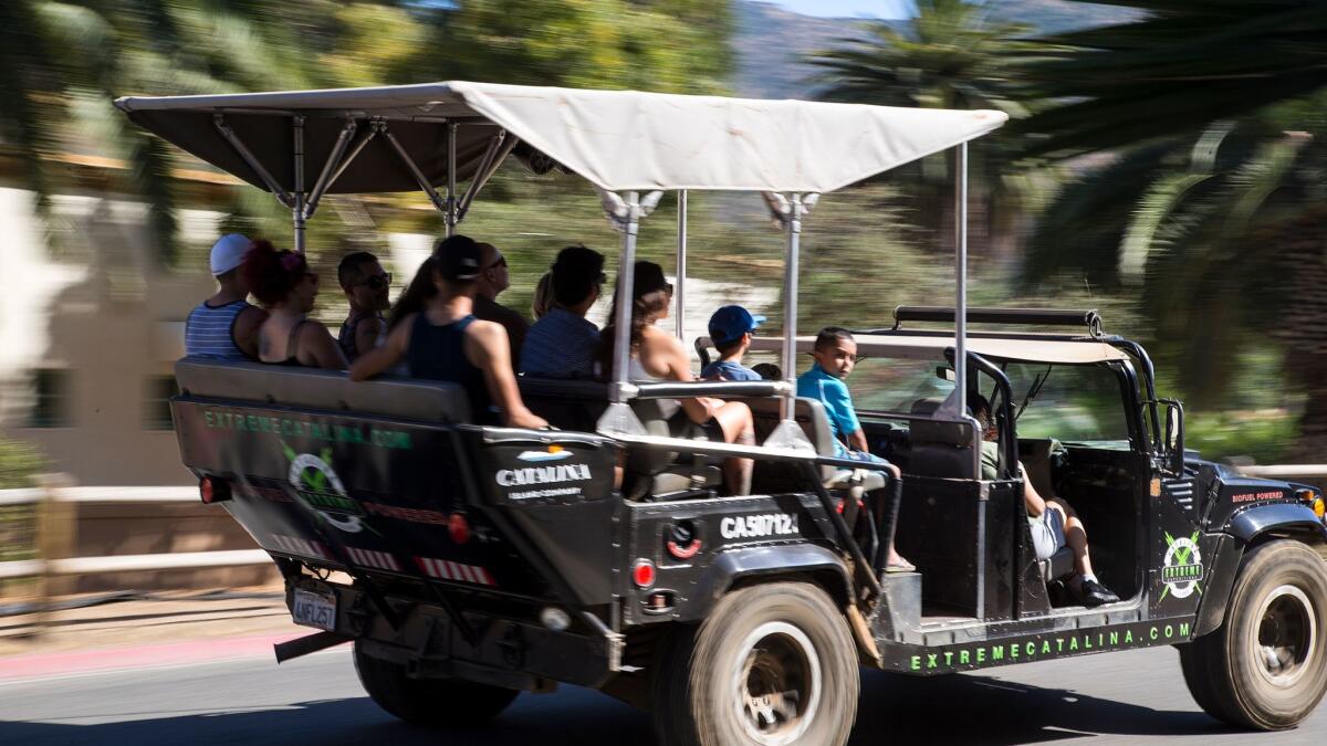 Customers are packed into a biofuel Hummer for a tour of the backcountry and sweeping views of Santa Catalina Island. (Gina Ferazzi / Los Angeles Times)