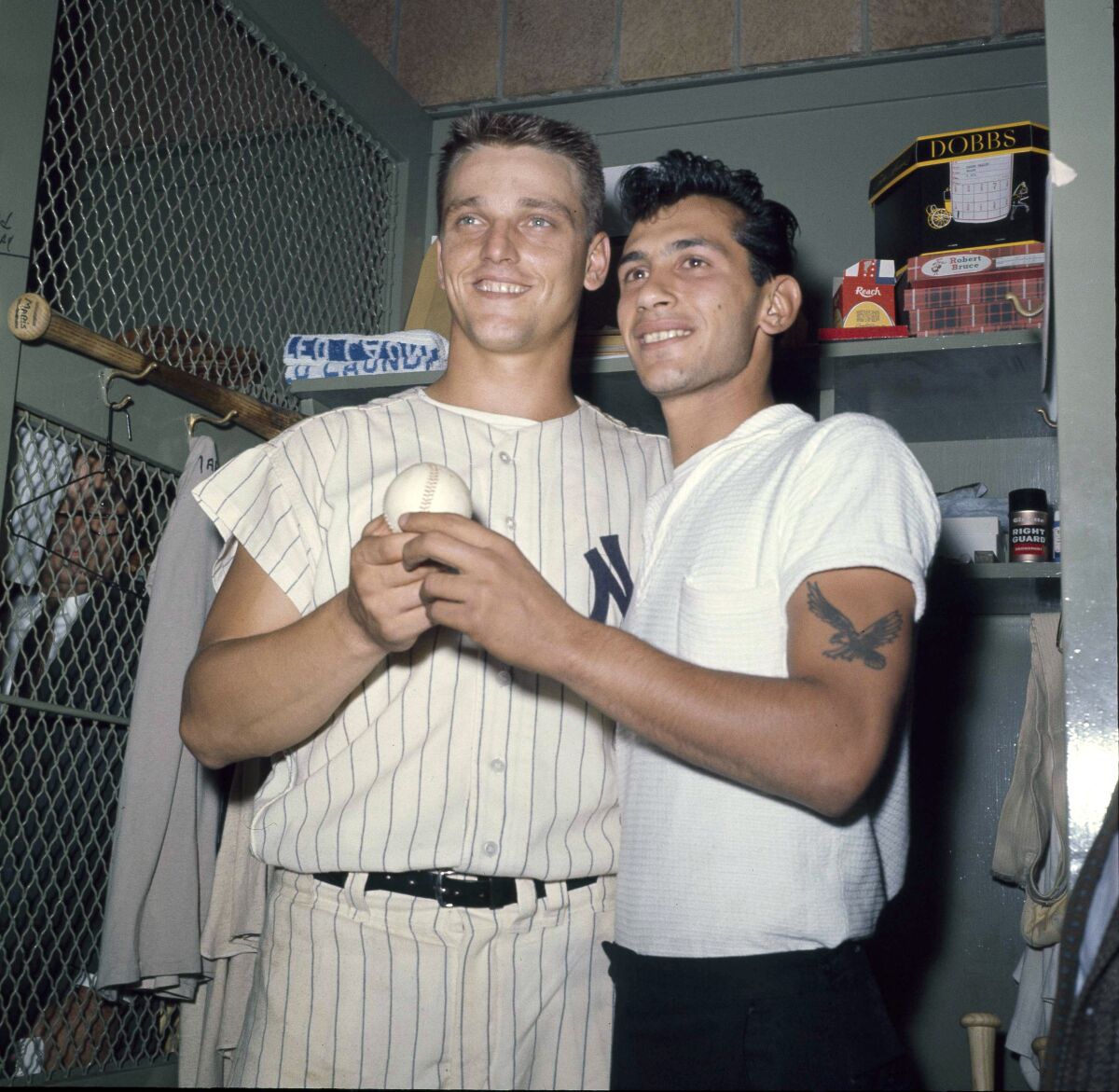 FILE - New York Yankees slugger Roger Maris poses with fan Sal Durante in the locker room at Yankee Stadium, Oct. 1, 1961, after hitting his 61st home run of the season. Durante caught Maris' fourth inning home run into the right field seats as Maris broke Babe Ruth's single-season home run record. If Aaron Judge passes Roger Maris, some lucky fan might become this generation's Sal Durante. (AP Photo/File)