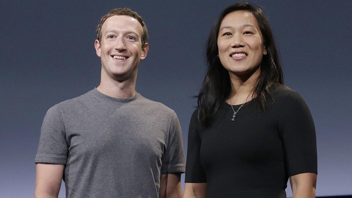 Facebook CEO Mark Zuckerberg and his wife, Priscilla Chan, smile as they prepare for a speech in San Francisco on Sept. 20, 2016.