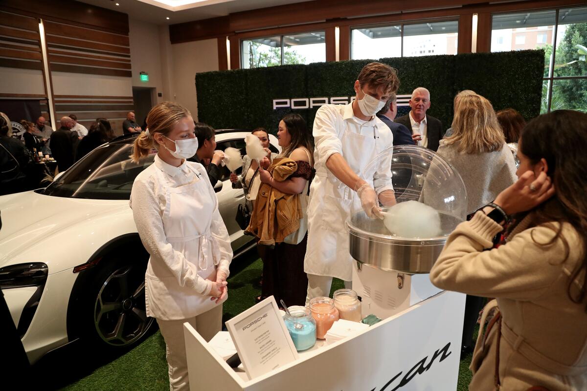 Workers with Porsche give out cotton candy during O.C. Restaurant Week at the Irvine Spectrum Marriott.