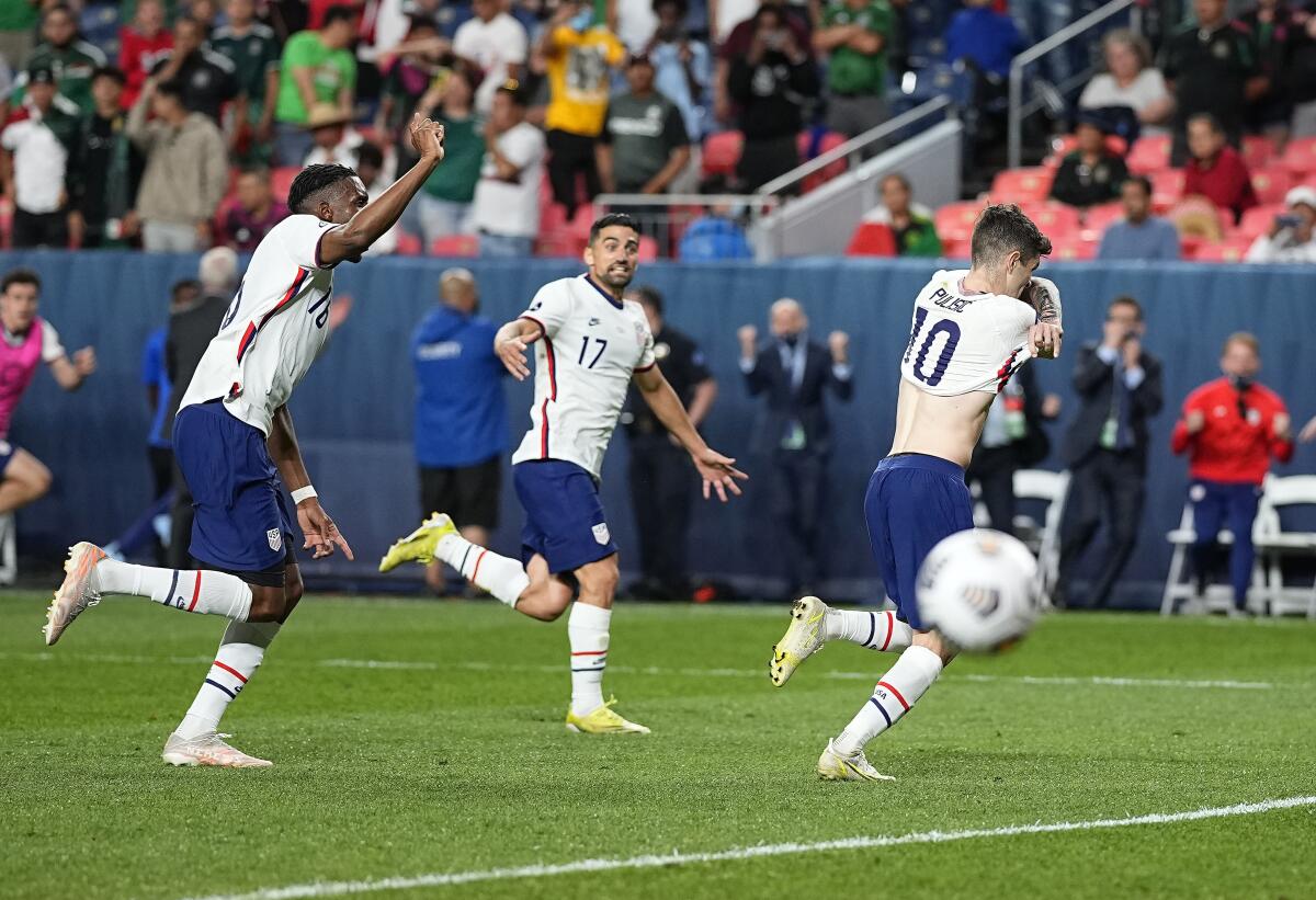 Christian Pulisic (10) celebrates scoring on a penalty kick 