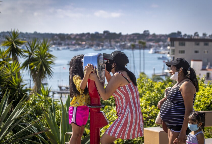 A family enjoys the view of Newport Harbor at Lookout Point.