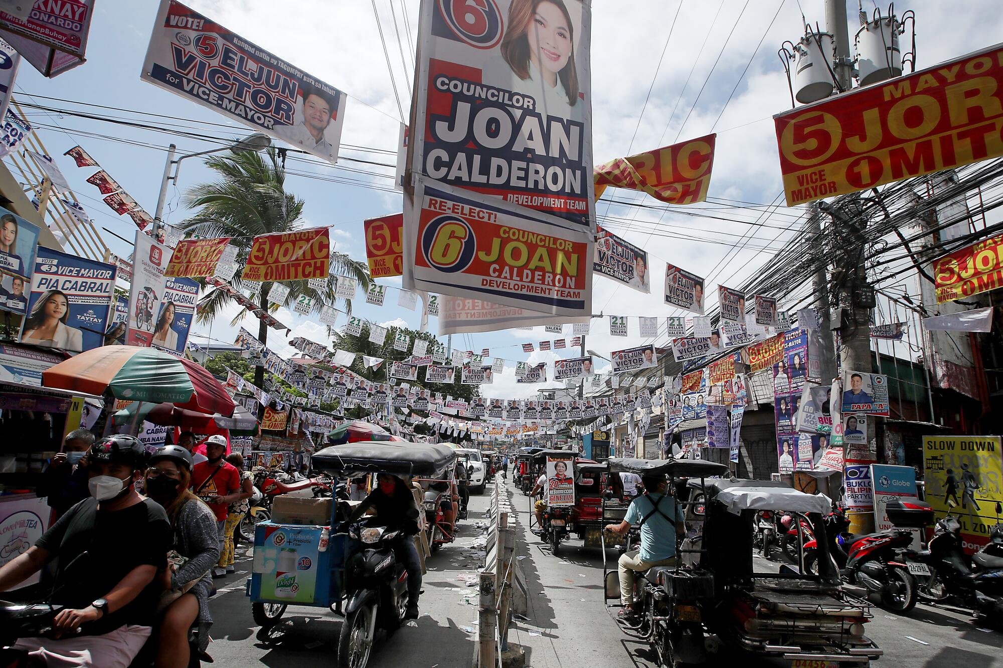 A street in the Manila suburb of Cainta is covered in campaign posters and banners