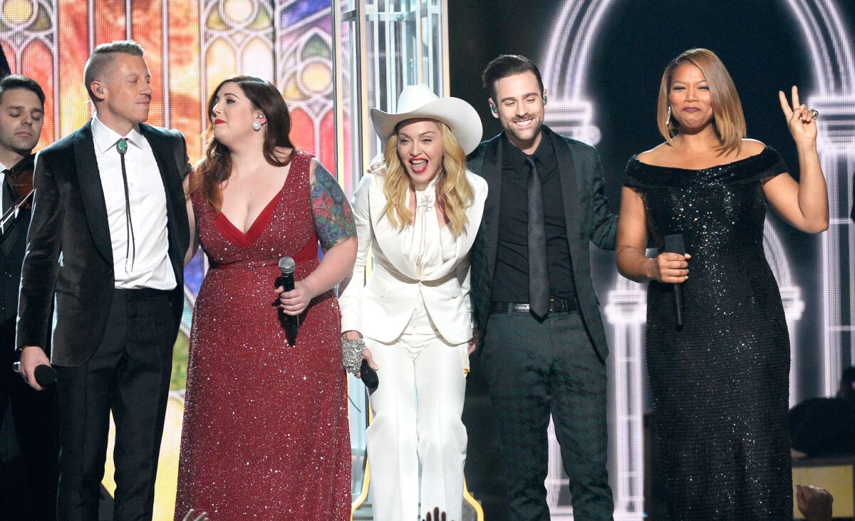 (L-R) Rapper Macklemore, singers Mary Lambert and Madonna, musician Ryan Lewis and Queen Latifah perform onstage during the 56th GRAMMY Awards at Staples Center on January 26, 2014 in Los Angeles, California. (Photo by Kevork Djansezian/Getty Images)