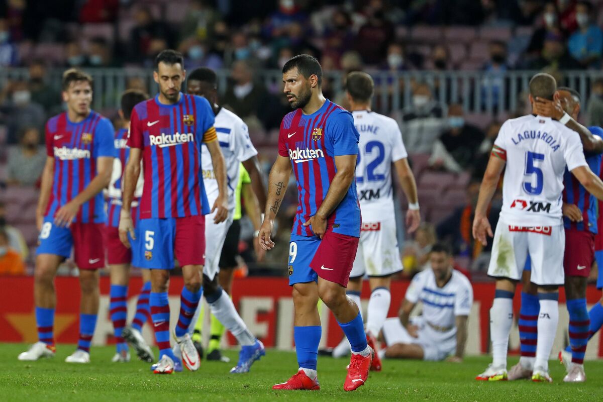 Barcelona's Sergio Aguero, center, leaves the pitch injured during the La Liga soccer match between Barcelona and Alaves at the Camp Nou stadium in Barcelona, Spain Saturday, Oct. 30, 2021. (AP Photo/Joan Monfort)