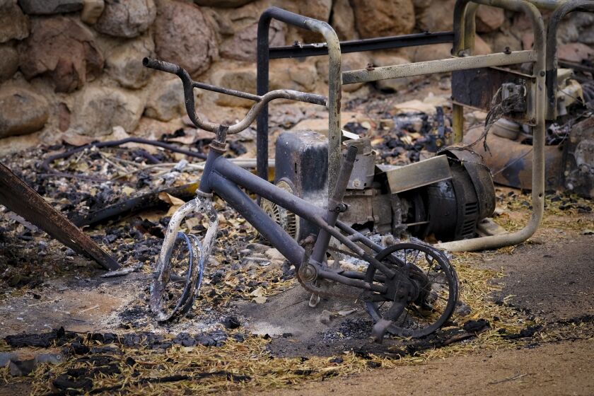 Dulzura, CA - September 08: A burned child’s bicycle at Barrett Junction stands at the burned lot where Micael Quintanilla home was before the fire burned the home to the ground. (Nelvin C. Cepeda / The San Diego Union-Tribune)