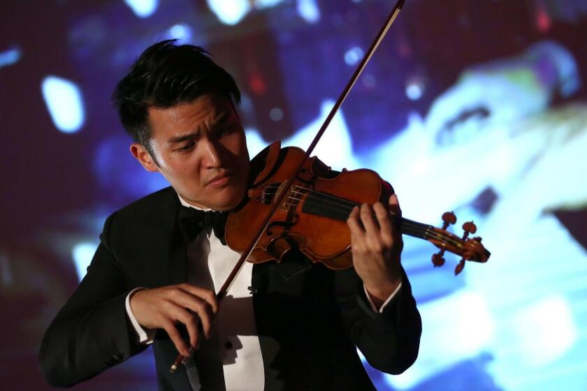 LONDON, ENGLAND - JUNE 02: Violinist Ray Chen performs at the IPO Summer Gala hosted by the British Friends of the Israel Philharmonic Orchestra at Rosewood London on June 2, 2014 in London, United Kingdom. (Photo by Tim P. Whitby/Getty Images for IPO) ** OUTS - ELSENT, FPG, CM - OUTS * NM, PH, VA if sourced by CT, LA or MoD **