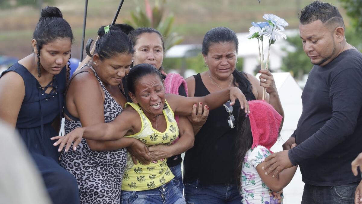 Antonia Alves grieves as she is comforted by relatives during the burial of her son Jairo Alves Figueiredo, an inmate who was killed in the recent prison riots, at a cemetery in Manaus, Brazil, on May 30, 2019.