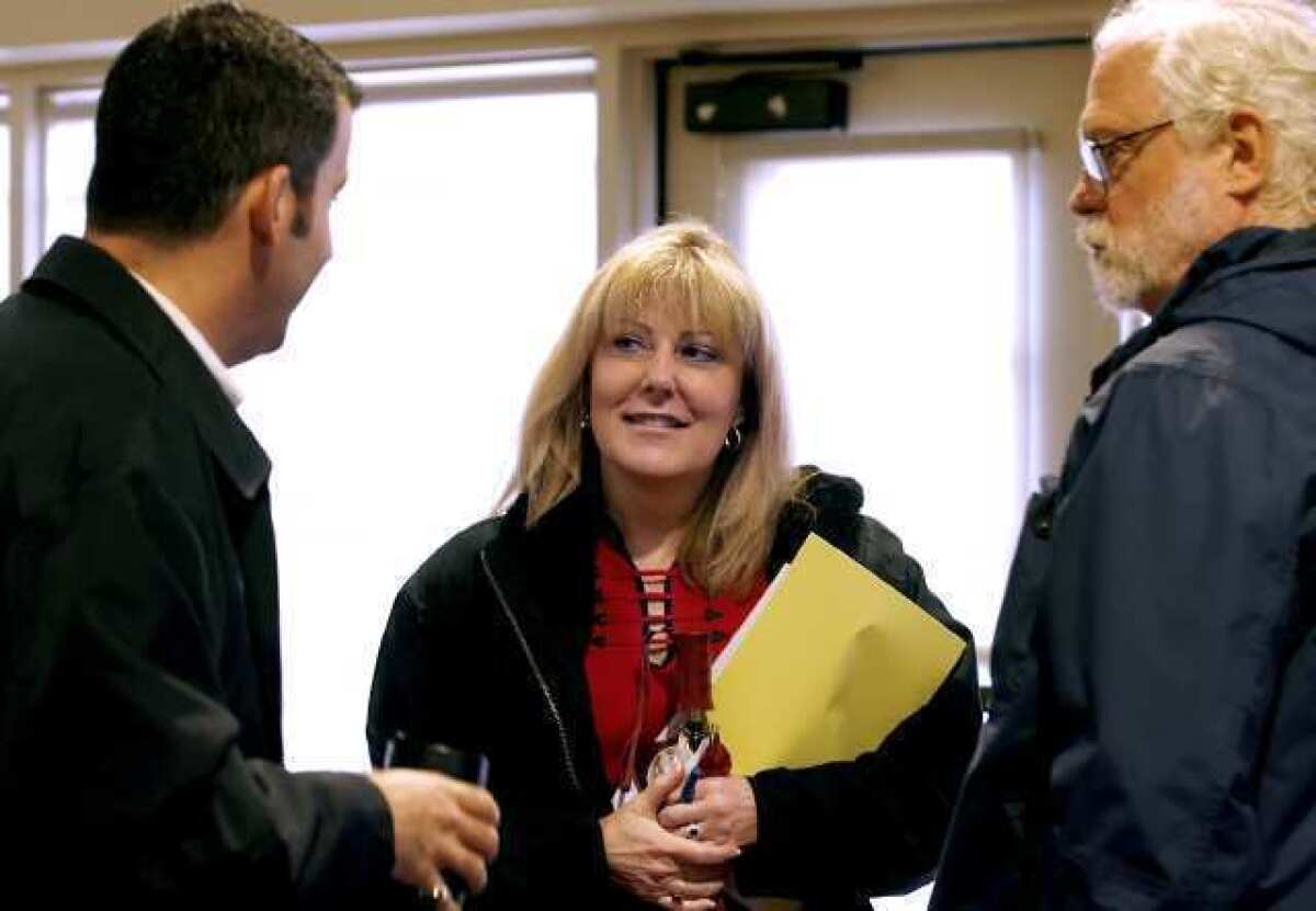 Outgoing President/Supt. Dawn Lindsay talks with Glendale Community College Board of Trustees member Tony Tartaglia, left, and political science professor John Queen after a meeting at the college.
