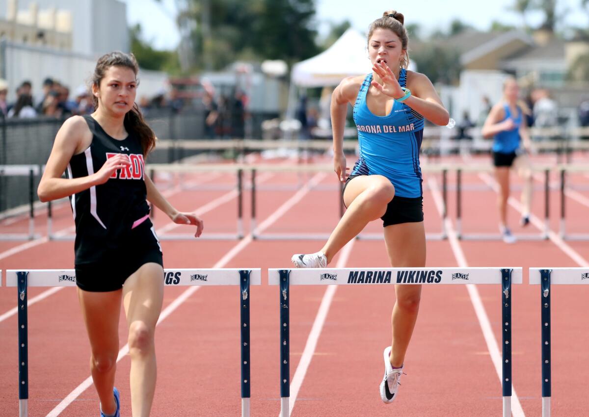 Corona del Mar's Paige Damron finishes in second place behind winner Isabella Ales of Troy in the 300-meter intermediate hurdles event of the Beach Cities Invitational at Huntington Beach High on March 23.