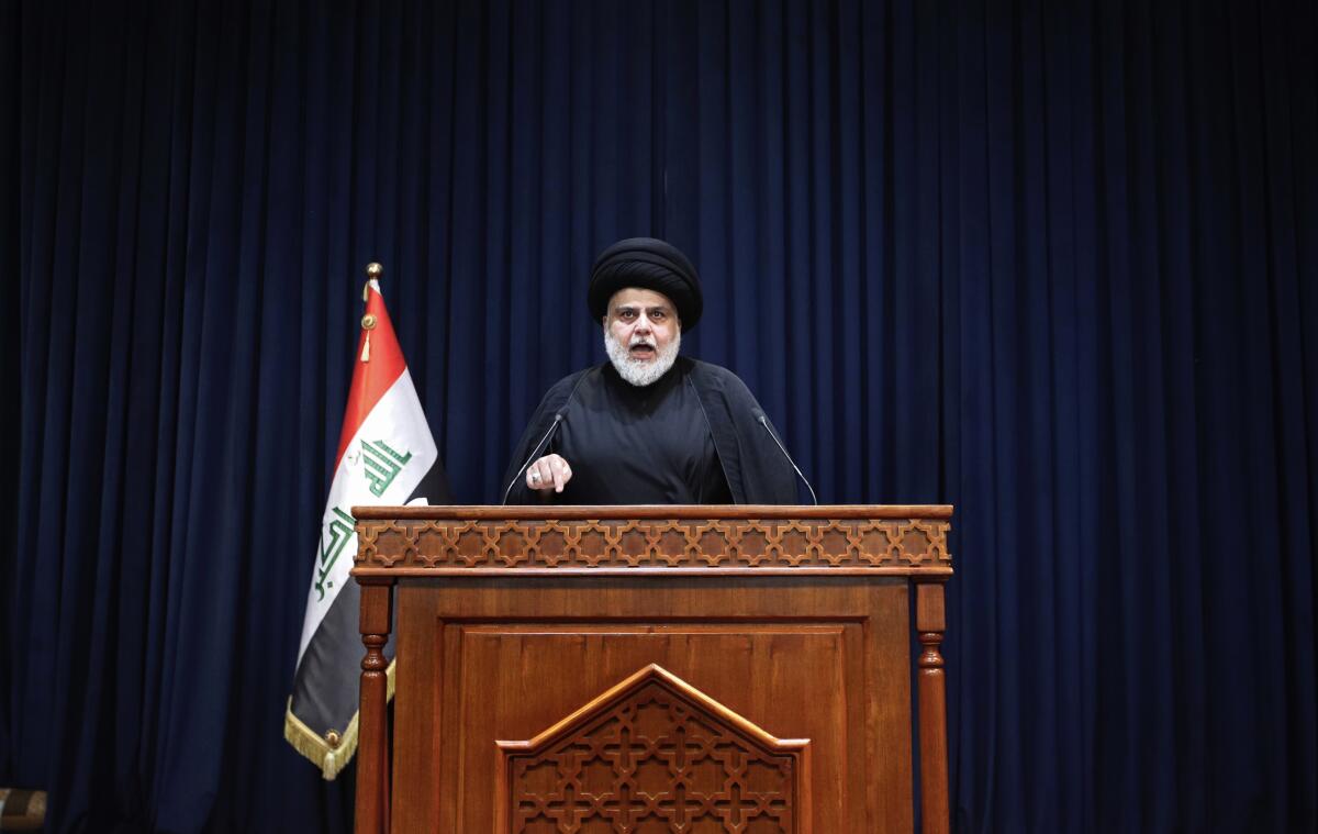 FILE - Influential Shiite cleric Muqtada al-Sadr, makes a speech calling on his supporters to withdraw from the capital's government quarter, from his house in Najaf, Iraq, Tuesday, Aug. 30, 2022. Normal life crept back in Baghdad Wednesday after a bloody 24 hours when the supporters of al-Sadr clashed with Iraqi security forces inside the heavily fortified Green Zone, the seat of Iraq's government. At least 30 people, both al-Sadr's loyalists and Iraqi security forces, were killed, and over 400 people were wounded. (AP Photo/Anmar Khalil, File)