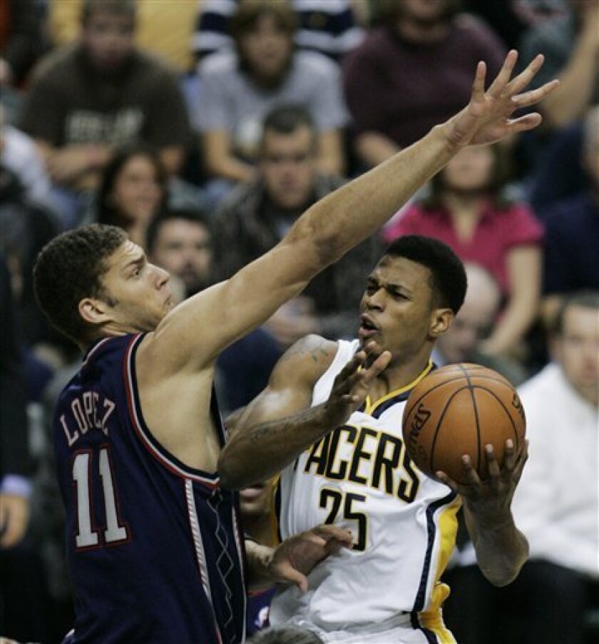 Indiana Pacers guard Brandon Rush (25) puts up a shot against New Jersey Nets center Brook Lopez (11) during the first quarter of an NBA basketball game in Indianapolis, Saturday, Nov. 8, 2008. (AP Photo/Darron Cummings)