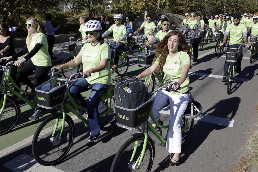 Riders test out new bicycles as part of a bike-share program in Santa Monica on Nov. 12, 2015.