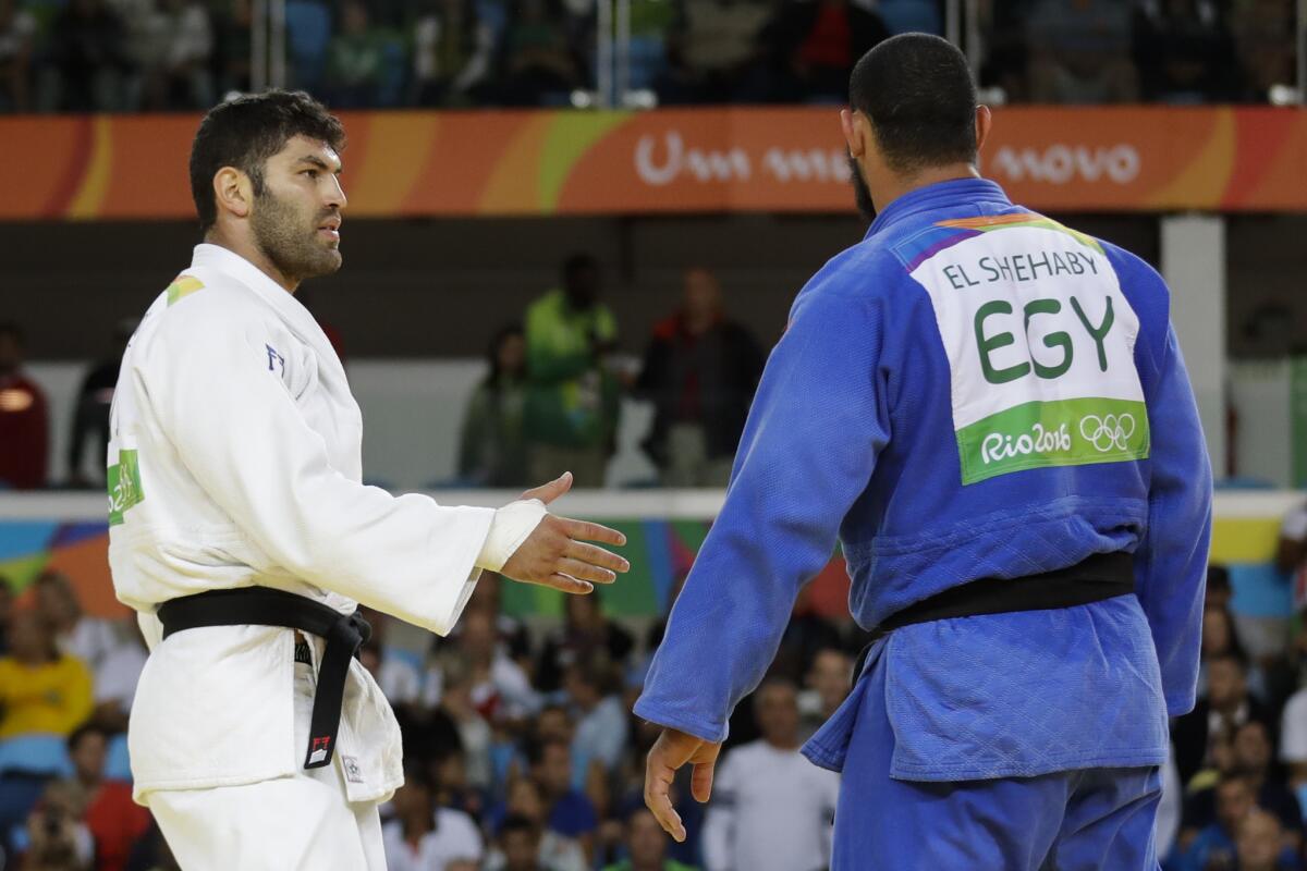 Egypt's Islam El Shehaby, in blue, declines to shake hands with Israel's Or Sasson, in white, after losing during the men's over 100 kg judo competition at the 2016 Summer Olympics.