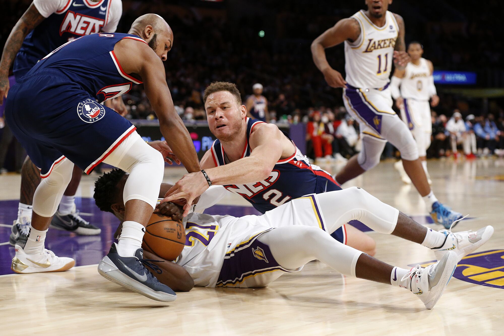Lakers guard Darren Collison fights for a loose ball with the Brooklyn Nets.