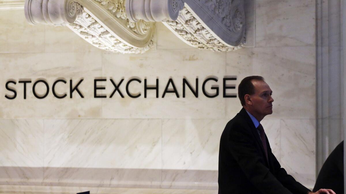 The Dow Jones industrial average rose 98.46 points, or 0.4%, to 24,216.05 on Thursday. Above, a trader works at the New York Stock Exchange in January.