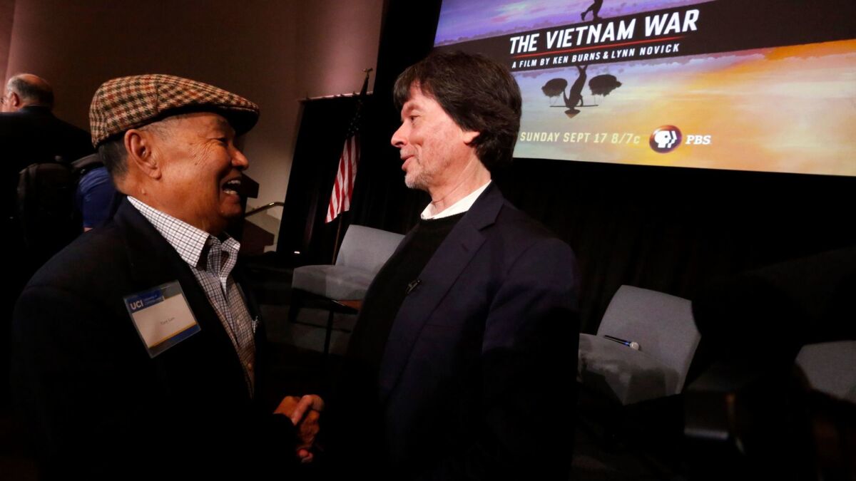 Tony Lam, the first Vietnamese-born person elected into a political office in the U.S. as city councilman for Westminster, left, congratulates documentary filmmaker Ken Burns after a screening of part of the documentary "The Vietnam War."