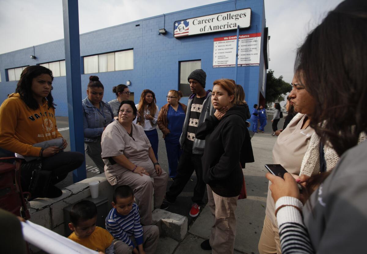Students stand outside Career Colleges of America in South Gate on Thursday morning.