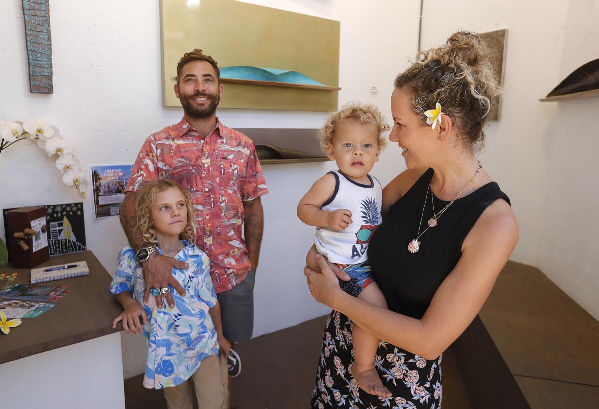 Sawdust artist Nevada Silva with wife Brittany and their two kids attend the Spirit of Aloha event.