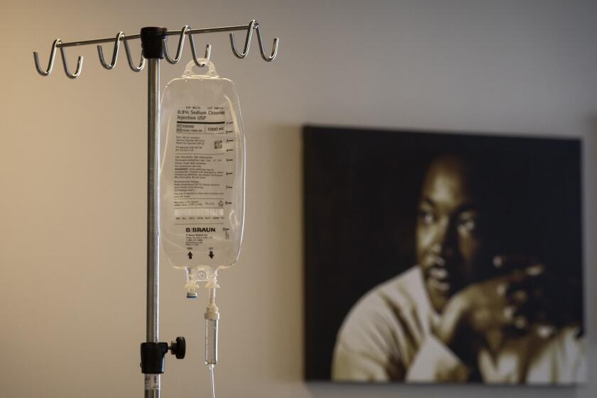 LOS ANGELES, CA - APRIL 15: During the coroniavirus global pandemic an IV bag hangs at Martin Luther King, Jr., Community Hospital on Wednesday, April 15, 2020 in the Emegancy Department in Los Angeles, CA. The IV bag is near a portrait of Dr. Martin Luther King. Martin Luther King, Jr., Community Hospital (MLKCH) is located in the Willowbrook neighborhood of South Los Angeles located between Compton and Watts. The hospital opened in 2015, replacing old Martin Luther King Jr./Drew Medical Center. (Francine Orr / Los Angeles Times)