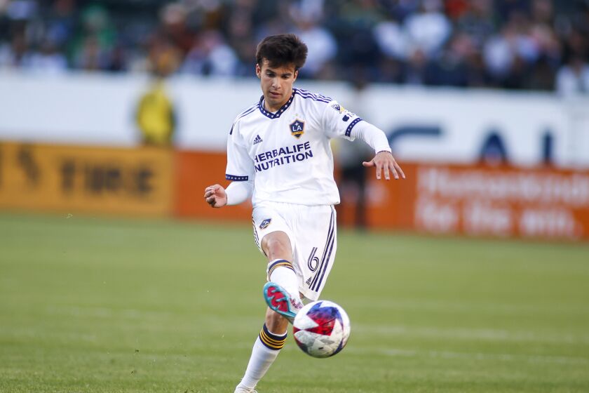 LA Galaxy midfielder Riqui Puig (6) passes the ball against the Seattle Sounders during the second half of an MLS soccer match in Carson, Calif., Saturday, April1, 2023. (AP Photo/Ringo H.W. Chiu)