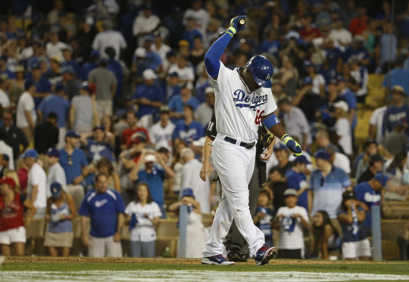 Dodgers center fielder Yasiel Puig reacts after striking out with the tying run at third base to end the game against the Cardinals on Friday night at Dodger Stadium.