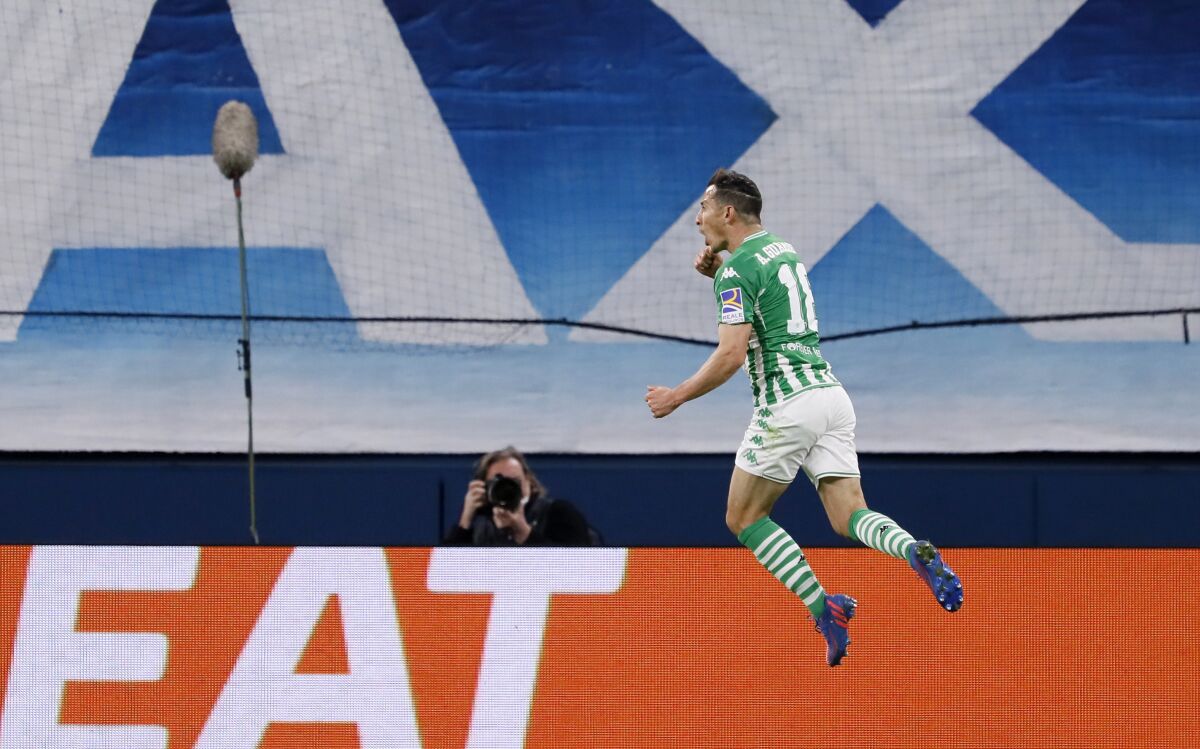 FILE - Betis' Andrés Guardado celebrates after scoring his side's third goal during the European League round of 16 first leg play-off soccer match between Zenit and Betis at Gazprom Arena in St. Petersburg, Russia, Feb. 17, 2022. Guardado will miss Mexico’s World Cup qualifier against the United States next week along with forward Rogelio Funes Mori and defender Julio César Domínguez. Guardado, Mexico’s captain, injured a thigh playing for Betis against Atlético Madrid on March 6. (AP Photo/Mike Kireev, File)