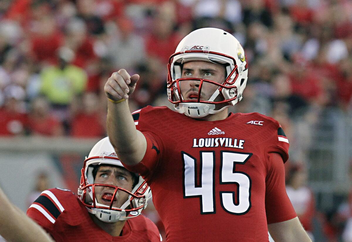 FILE - Louisville place kicker John Wallace (45) watches as his second of three field goal attempts goes through the uprights in a 20-10 win over Wake Forest in a NCAA college football game in Louisville, Ky., Saturday, Sept. 27, 2014. Former Louisville place kicker John Wallace, whose school-record 66 career field goals included two in a 2013 Sugar Bowl upset of Florida, has died, Wednesday, May 15, 2024. He was 31.(AP Photo/Garry Jones, File)