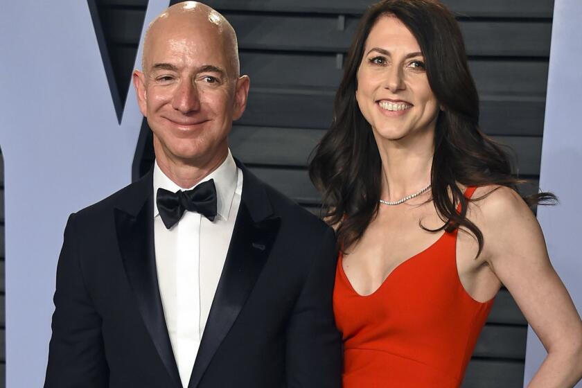 FILE - In this March 4, 2018 file photo, Jeff Bezos and wife MacKenzie Bezos arrive at the Vanity Fair Oscar Party in Beverly Hills, Calif. The founder of Amazon and his wife have made their largest political donation to date, giving $10 million to With Honor, a nonpartisan political-action committee devoted to helping military veterans running for Congress. (Photo by Evan Agostini/Invision/AP, File)
