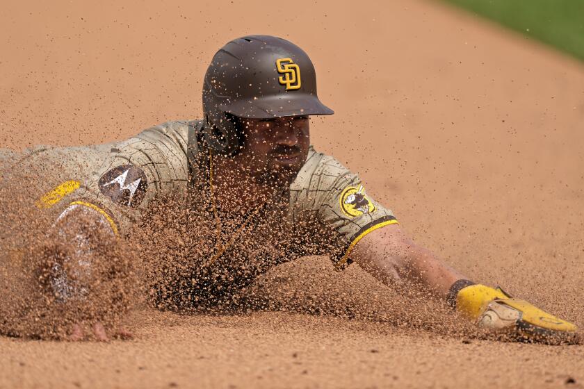 San Diego Padres' Tyler Wade slides to third as he advances on a throwing error by pitcher Kansas City Royals relief pitcher Angel Zerpa during the eighth inning of a baseball game Sunday, June 2, 2024, in Kansas City, Mo. (AP Photo/Charlie Riedel)