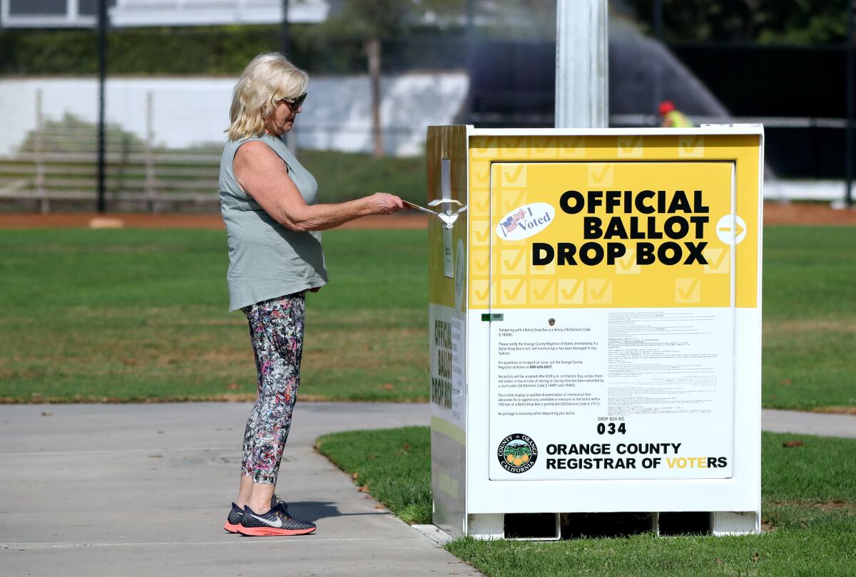 Cecelia Decrona of Newport Beach, drops off her ballot at adrop box at Bob Henry Park, in Newport Beach in October 2020.