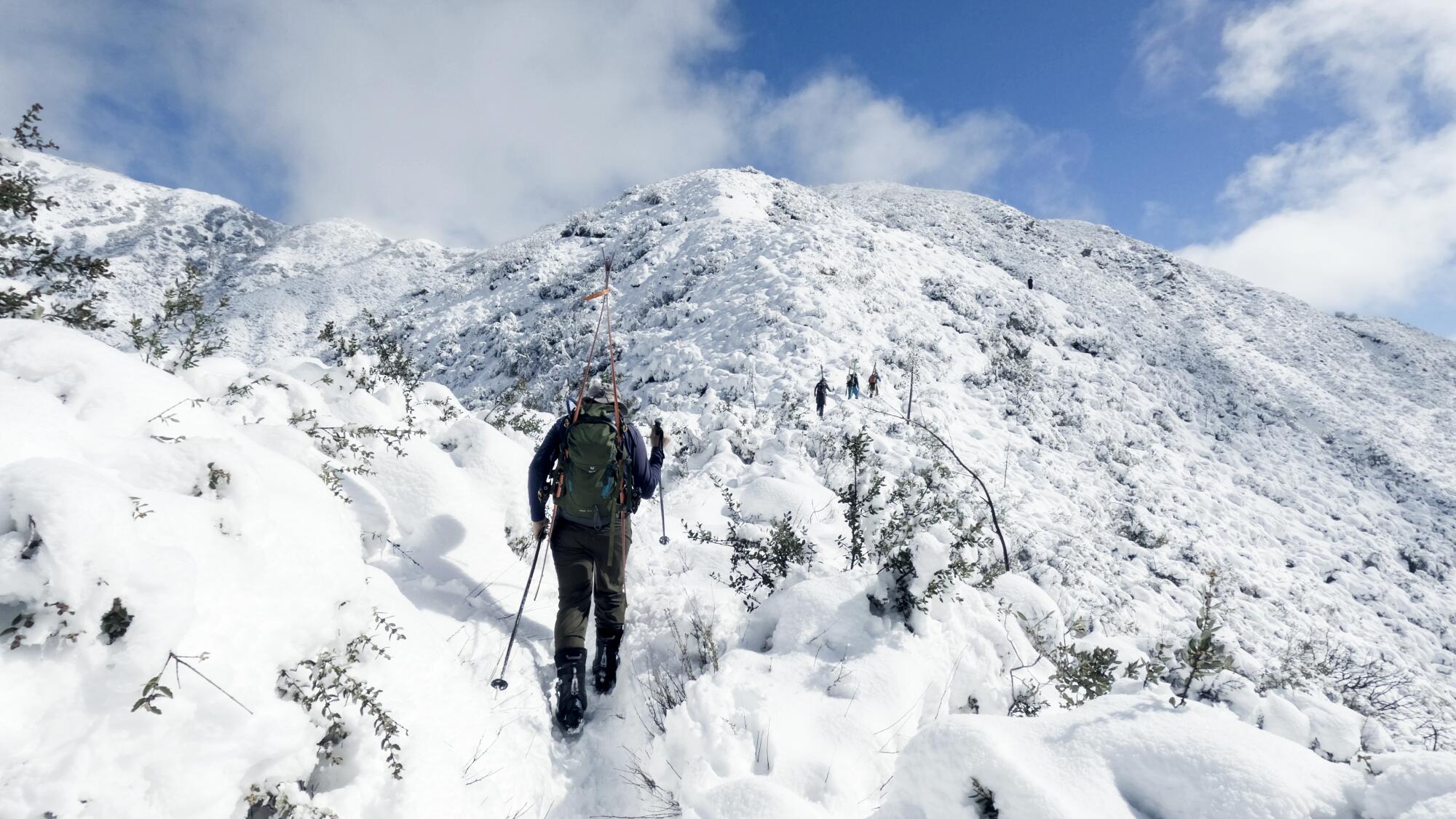 Skiers make their way to the summit of Mt. Lukens.