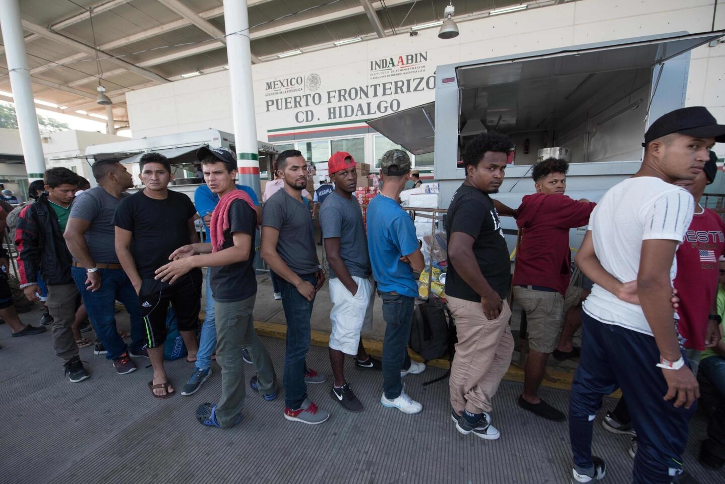 Central American migrants heading to the United States wait for immigration officials to give them a humanitarian visitor card to continue on their journey, in Ciudad Hidalgo, Mexico.