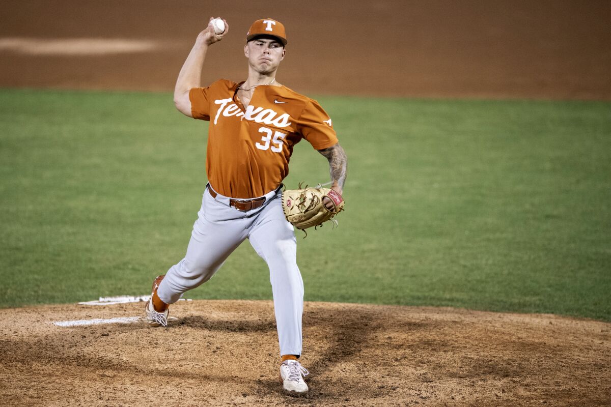 Texas' Tristan Stevens throws a pitch during the first inning of an NCAA college super regional baseball game against East Carolina on Sunday, June 12, 2022, in Greenville, N.C. (AP Photo/Matt Kelley)