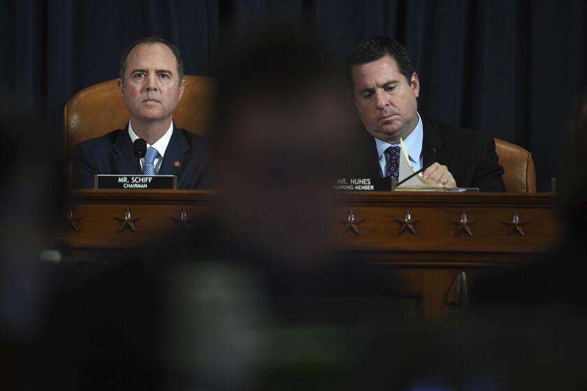 House Intelligence Committee Chairman Adam Schiff, D-Calif., left, and ranking member Rep. Devin Nunes of Calif., right, question former White House national security aide Fiona Hill and David Holmes, a U.S. diplomat in Ukraine, during testimony before the House Intelligence Committee on Capitol Hill in Washington, Thursday, Nov. 21, 2019, during a public impeachment hearing of President Donald Trump's efforts to tie U.S. aid for Ukraine to investigations of his political opponents. (Matt McCain/Pool Photo via AP)