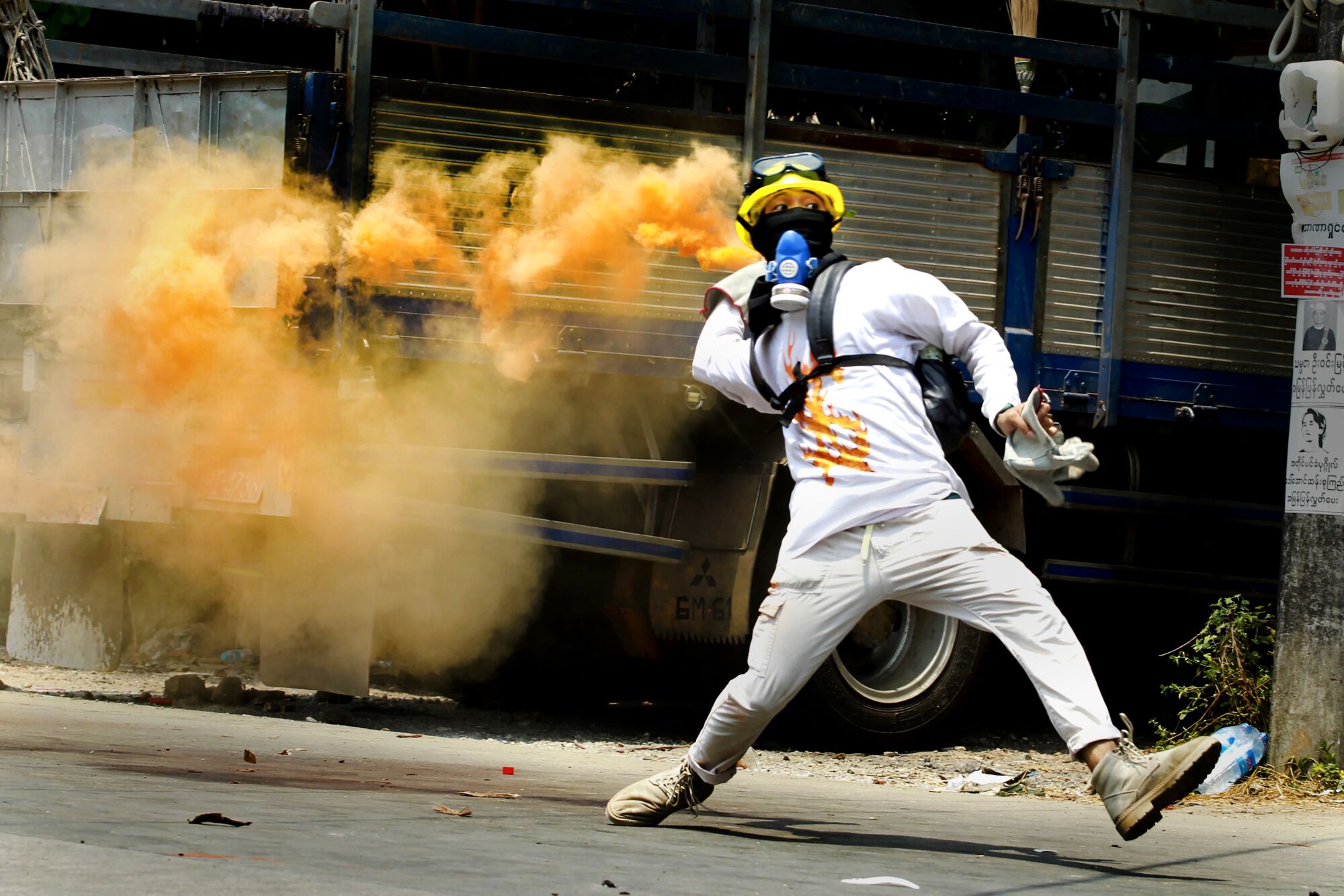 A protester throws a smoke bomb.