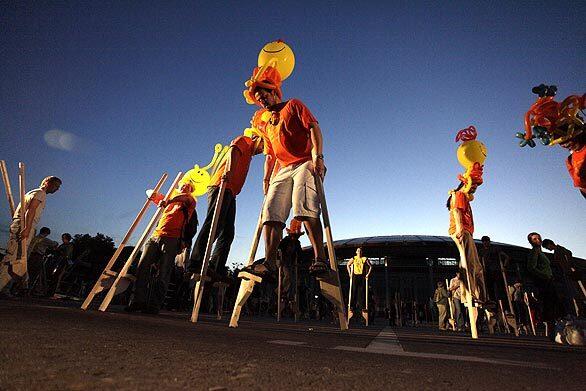 Russians take part in a mass stilt-walk to celebrate the 25th anniversary of Cirque du Soleil in Moscow.