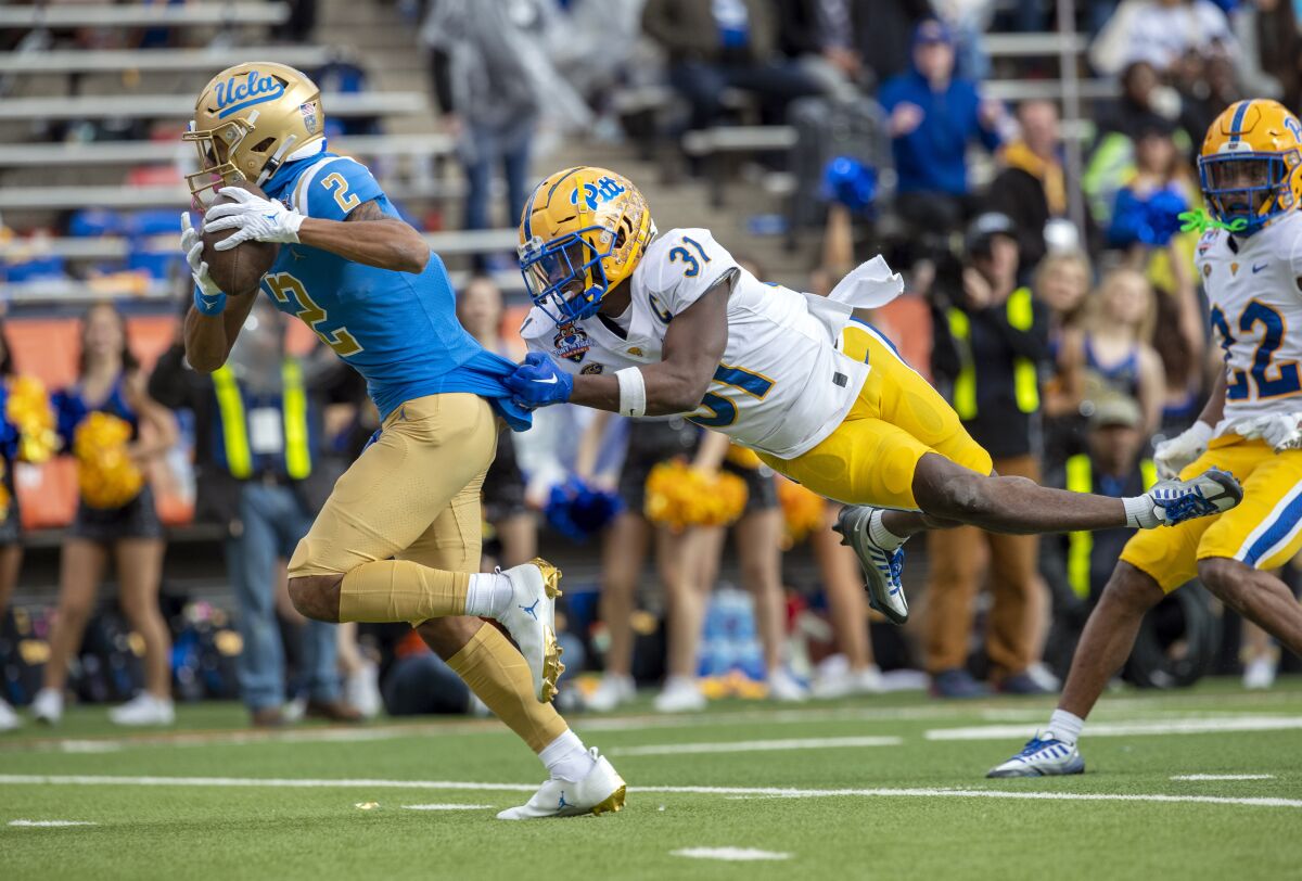 UCLA wide receiver Titus Mokiao-Atimalala goes to the end zone for a touchdown.