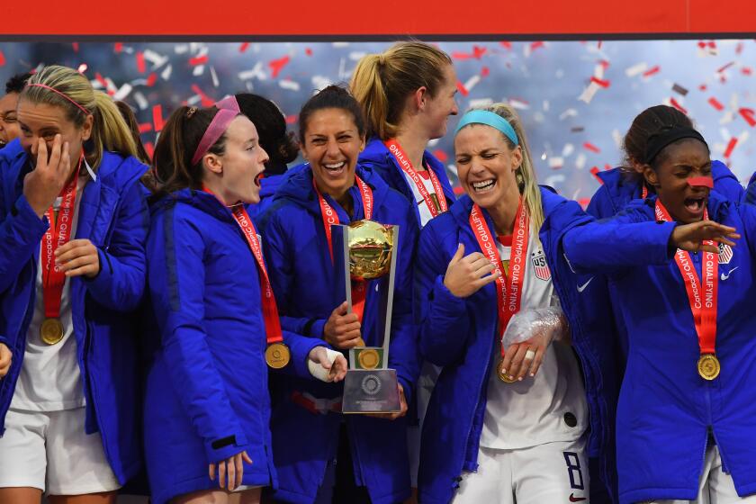 CARSON, CA - FEBRUARY 09: Carli Lloyd (C) and fellow United States team-mates celebrate after defeating Canada in the CONCACAF Women's Olympic Qualifying Final 3-0 at Dignity Health Sports Park on February 9, 2020 in Carson, California. (Photo by Jayne Kamin-Oncea/Getty Images)