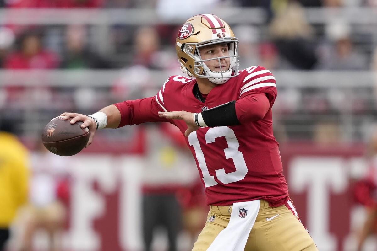 San Francisco 49ers quarterback Brock Purdy (13) throws a touchdown pass to running back Christian McCaffrey during the first half of an NFL football game against the Tampa Bay Buccaneers in Santa Clara, Calif., Sunday, Dec. 11, 2022. (AP Photo/Tony Avelar)